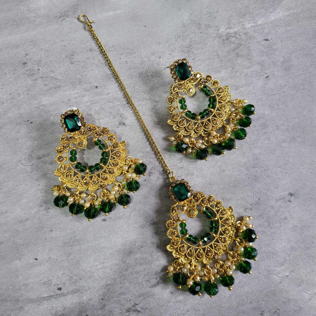 green earrings and mang tikka set