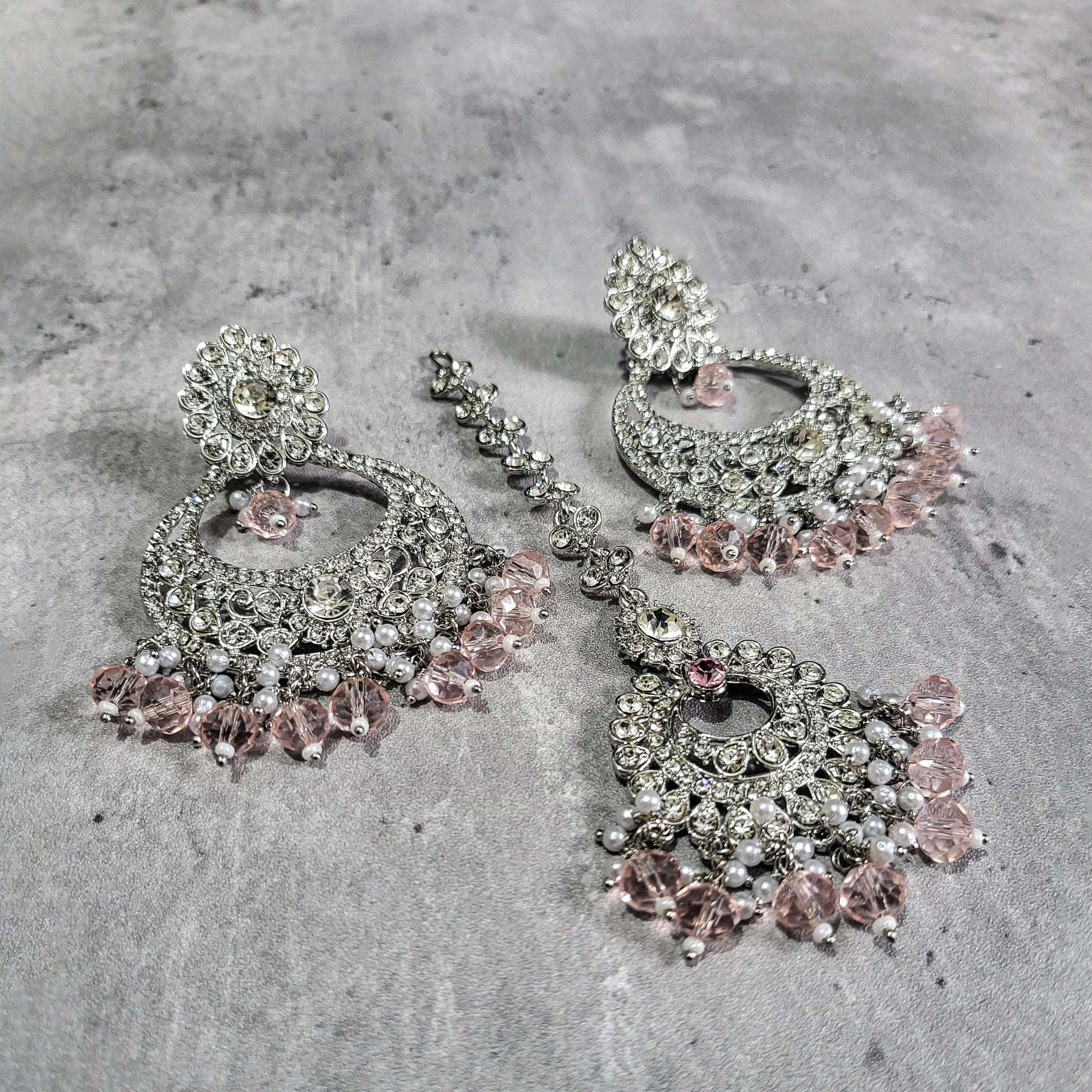 silver and baby pink earrings tikka set