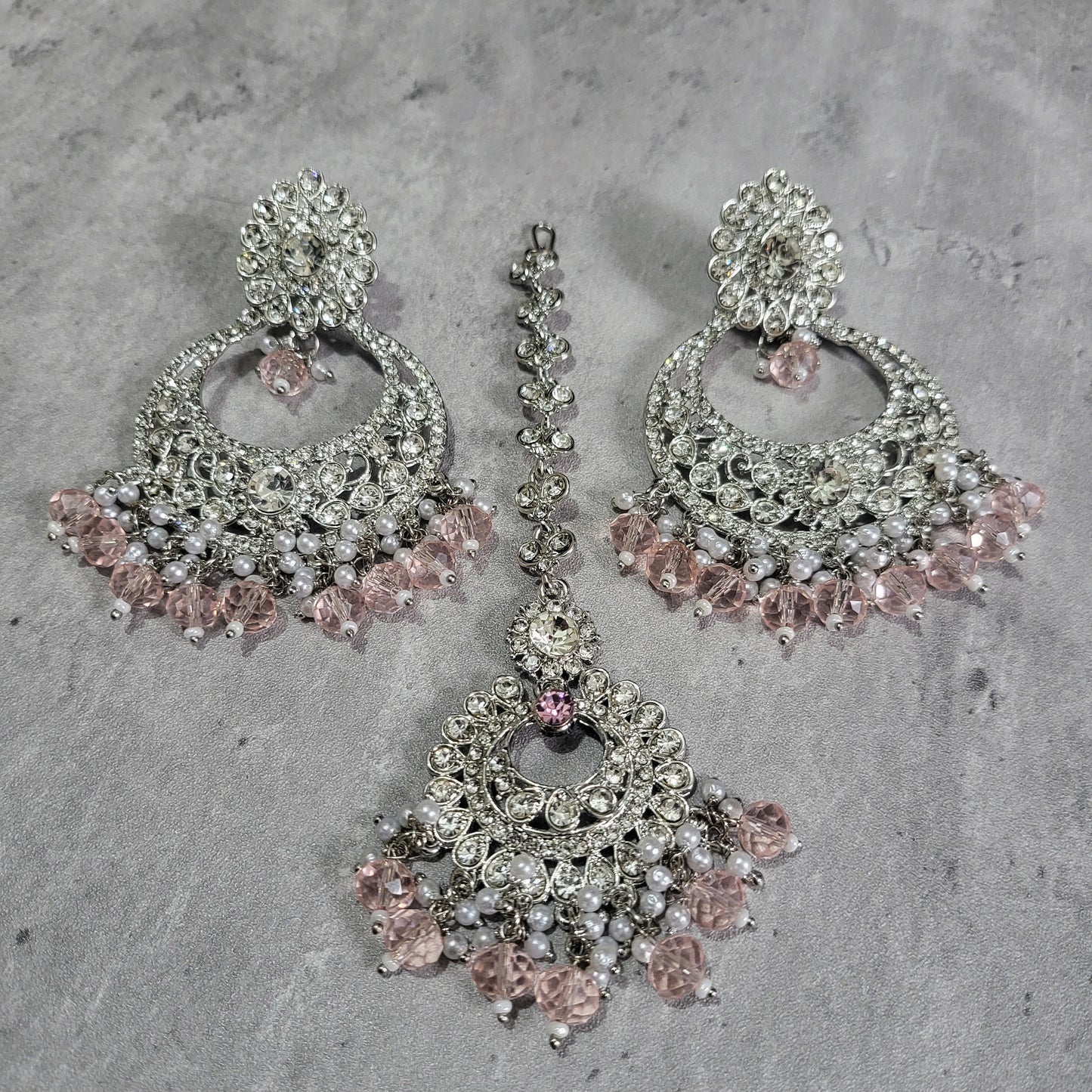 silver and baby pink earrings tikka set